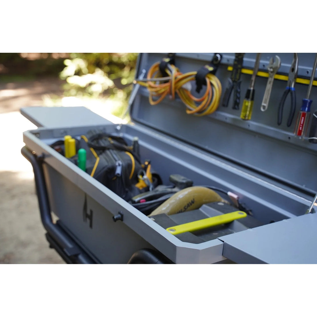 Toolbox with tools and equipment on a blurred outdoor background