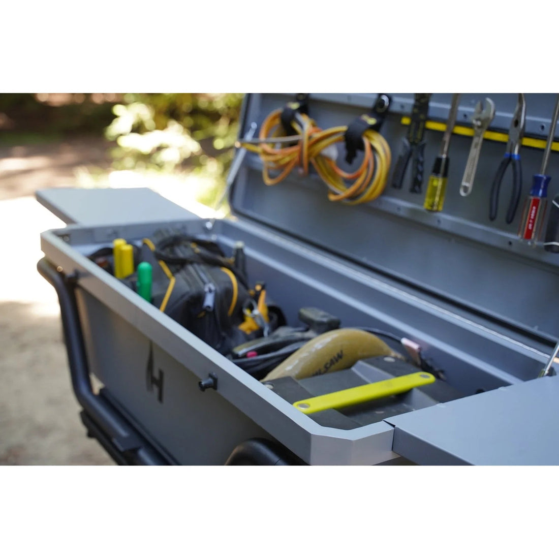 Toolbox with tools and equipment on a blurred outdoor background