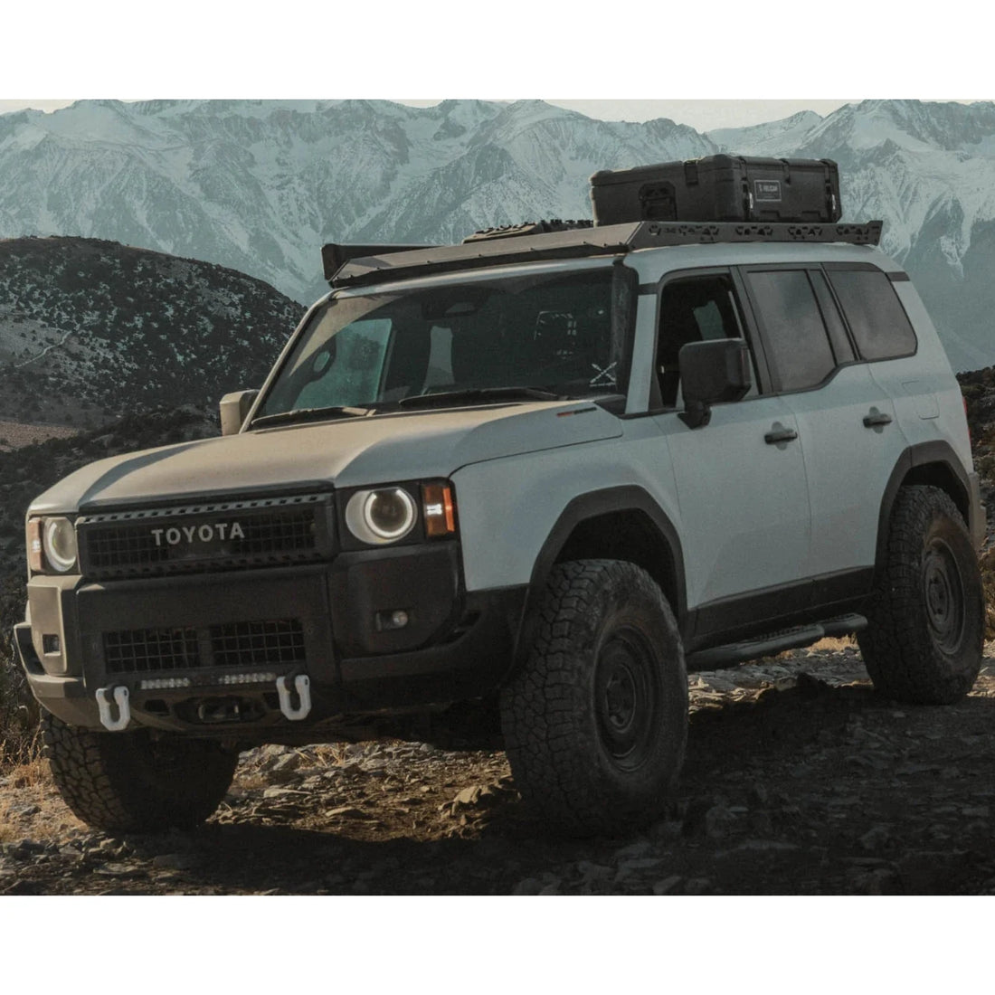 Toyota SUV with roof rack in a mountainous landscape