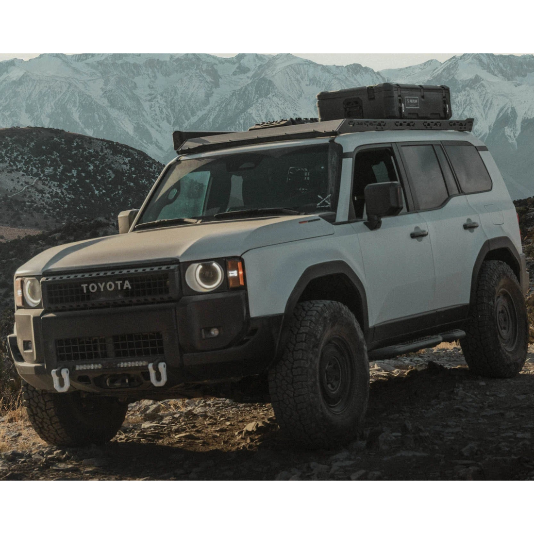 Toyota SUV with roof rack in a mountainous landscape