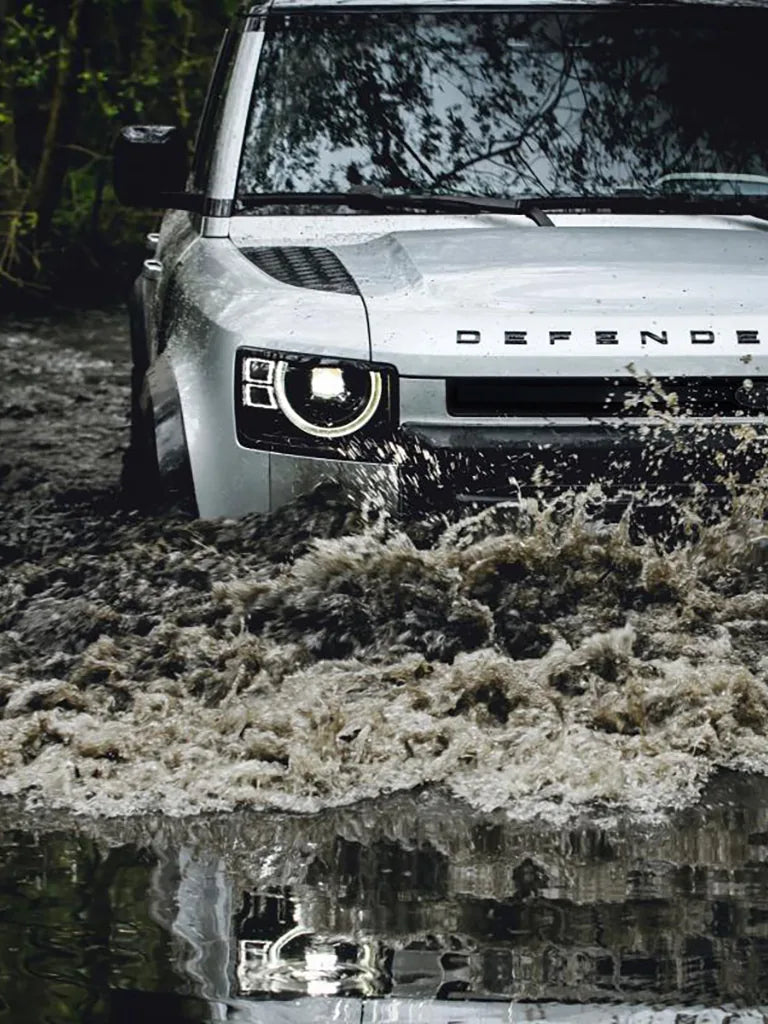 New Land Rover Defender driving through deep water
