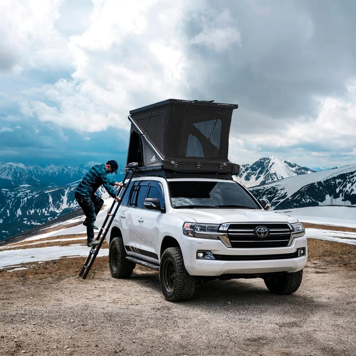Tuff Stuff Alpine SixtyOne aluminum shell rooftop tent open on an SUV in the mountains