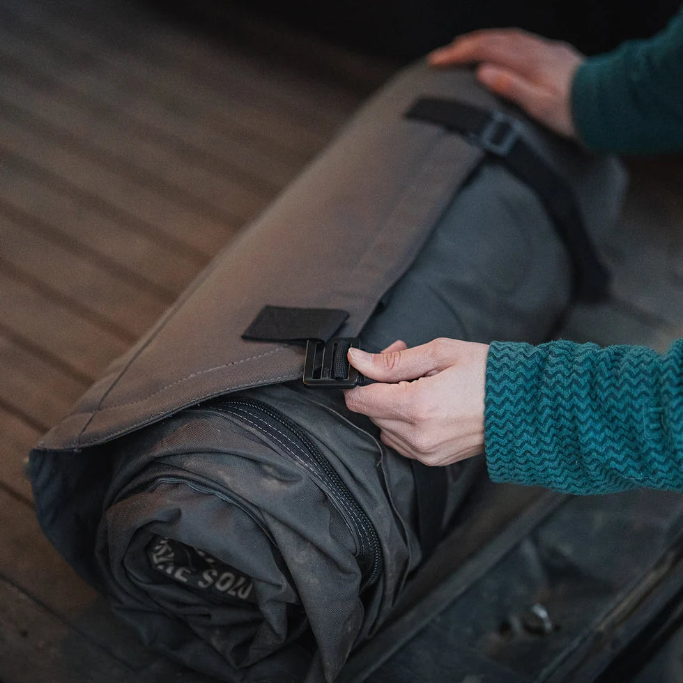 Luno AIR Pro mattress rolled up and cinched with the head support bridge attachment straps