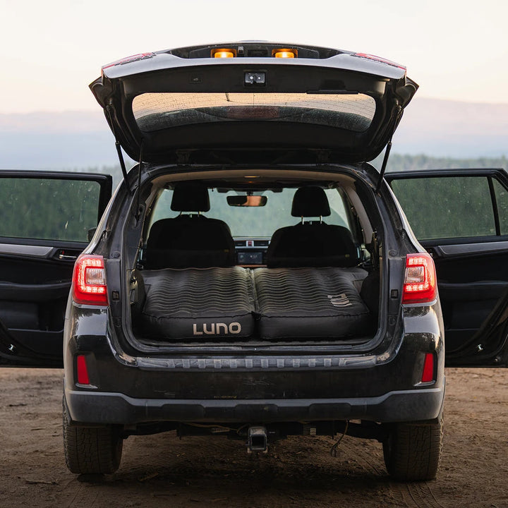 Luno AIR Pro Full-Size SUV mattress set up in a Subaru Outback with the rear hatch open