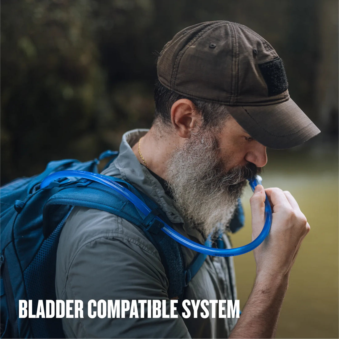 Drinking from a hydration reservoir carried in the Mission EXP Backpack