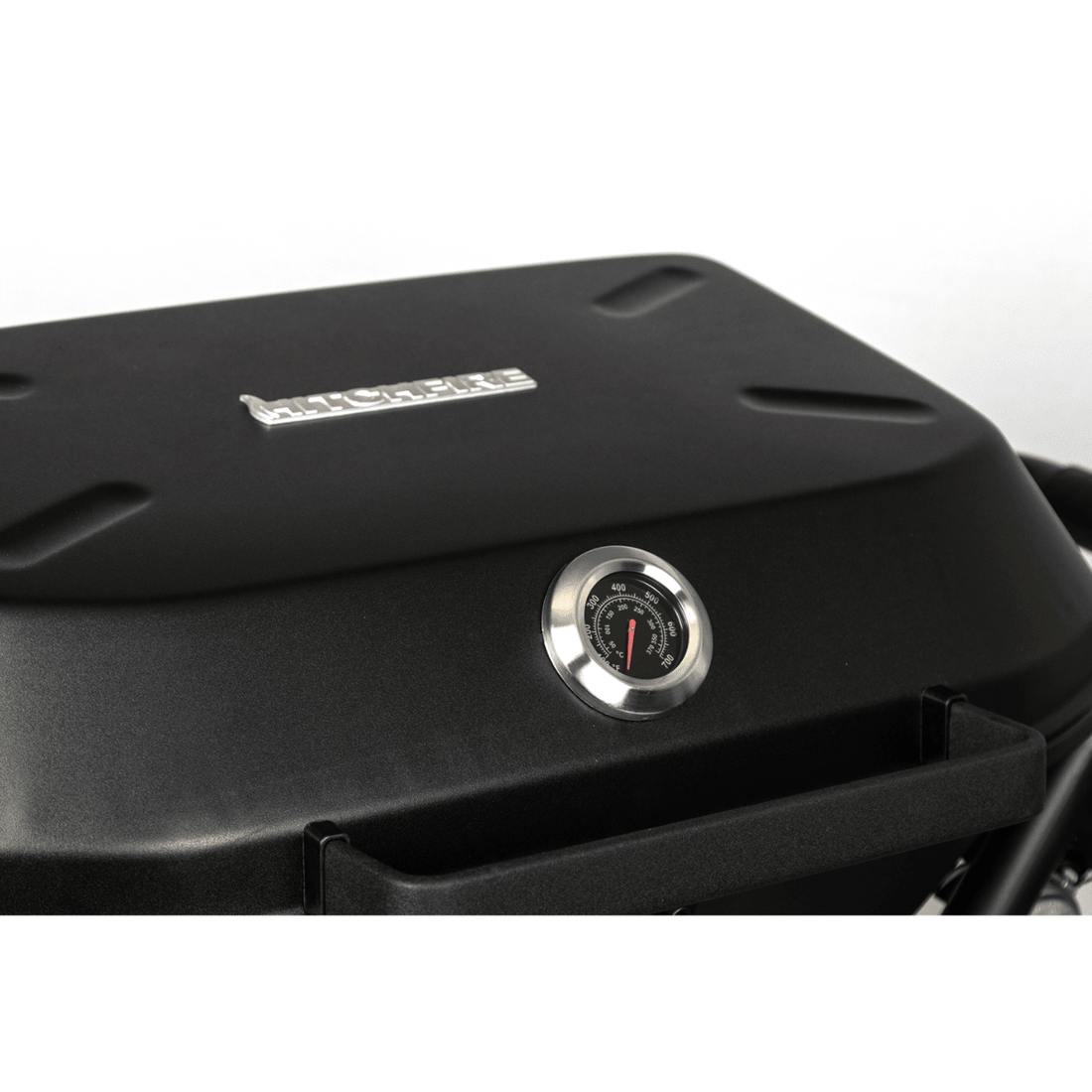 Black barbecue grill with a temperature gauge on a white background