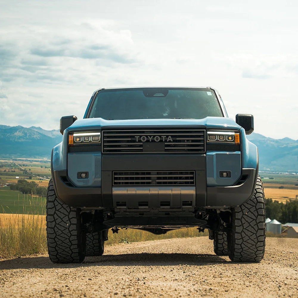 Land Cruiser 250 with CBI grille on a dirt road