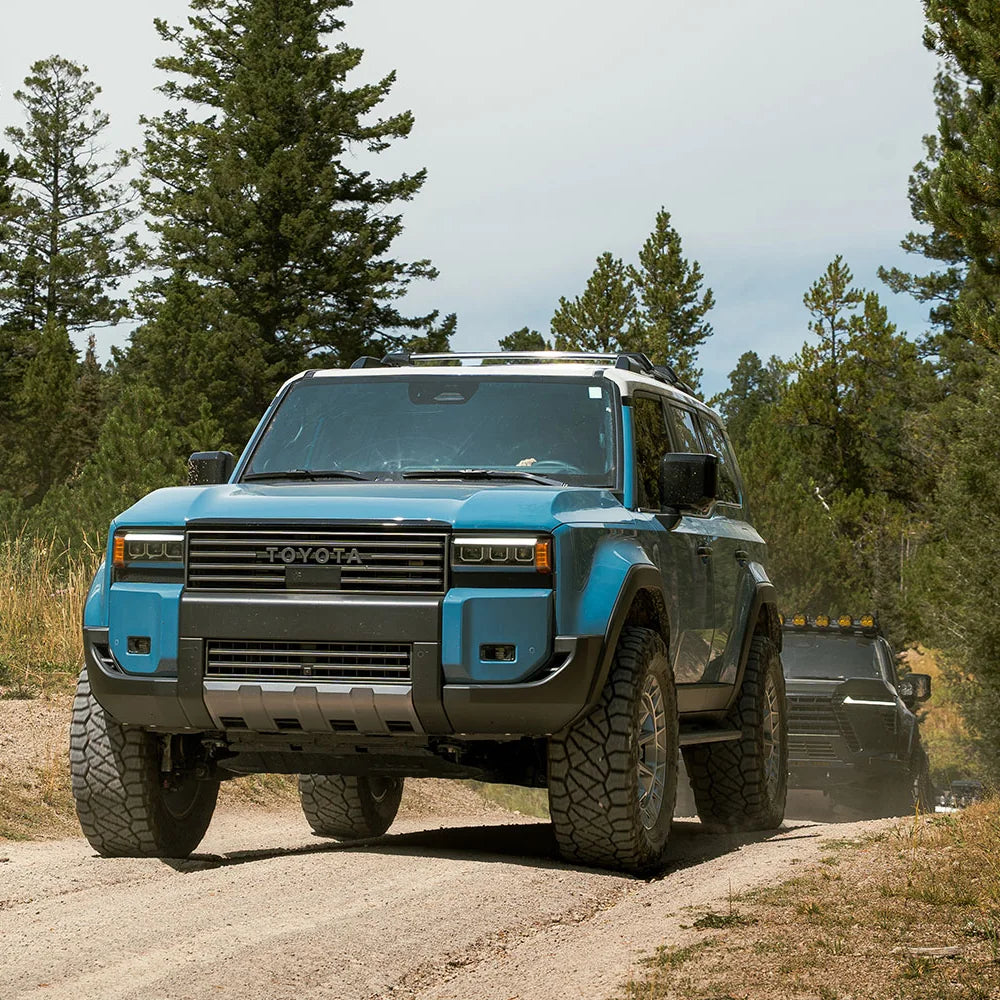 Blue Land Cruiser 250 with CBI Heritage grille on a forest trail