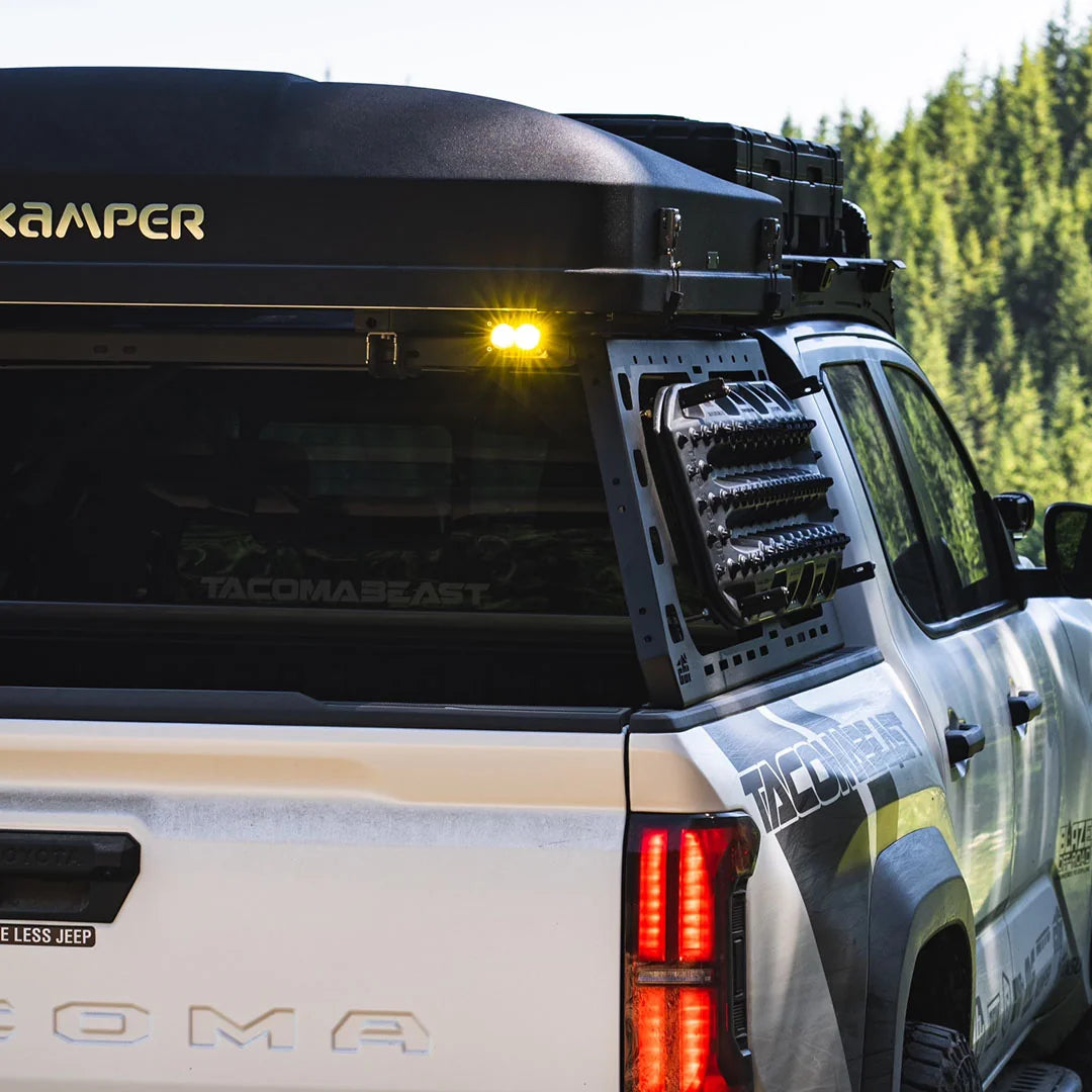 Rear quarter of a 4th Gen Tacoma with CBI bed rack and rooftop camper