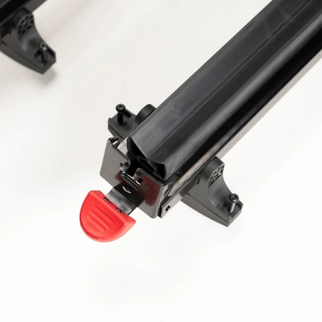 Close-up of a Squall6 Ski Rack with a red lever on a white background