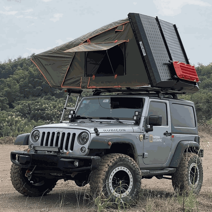 Tuff Stuff Stealth rooftop tent open on a Jeep Wrangler at camp