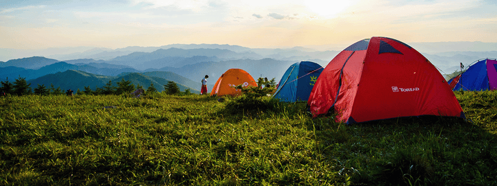 Setting up camp on the mountain side at sunset